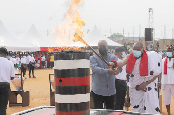 Former President John Mahama (left), and Nii Lante Otanka II (right), Lante Djan We Mantse, jointly lighting the perpetual flame to commemorate the 31st December Revolution in Accra