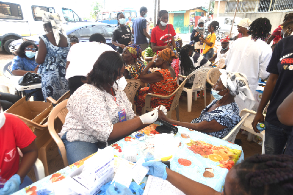 A section of the medical team taking some of the residents of Chorkor in Accra through the medical check up