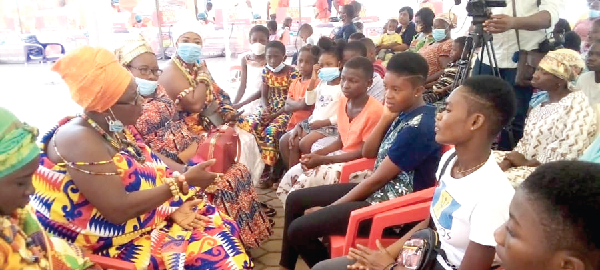 Nana Akua Darkoa Ampem I (seated left), the Benkumhemaa of Larteh, being supported by other queen mothers to interact with teenage girls about the dangers of teenage pregnancy and other challenges the girls go through while at home