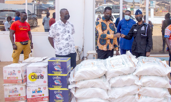 Dr Yaw Osei Adutwum (3rd left), the Member of Parliament for Bosomtwe, presenting the items to DSP Eric Akwaboah at Jachie