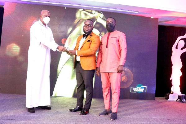 Mr Ato Afful (left), MD, Graphic Communications Ltd, presenting a Platinum Award to a representative of EXP Ghana