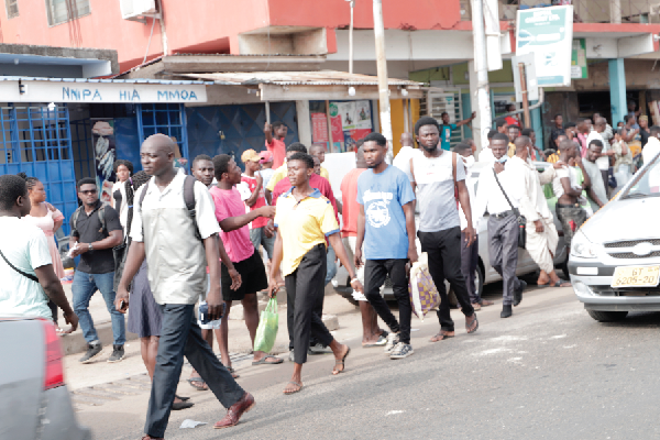 Some stranded passengers trekking along the Lapaz-Abeka road