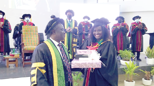 Miss Elizabeth Naa Abiana Morton (right) receiving one of her 9 awards from Prof. John Owusu Gyapon, Vice Chancellor of UHAS.
