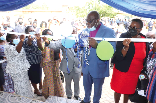 Rt Rev. Prof. Joseph Obiri Yeboah Mante (2nd from right), Moderator of the PCG, cutting the tape to dedicate the clinic.