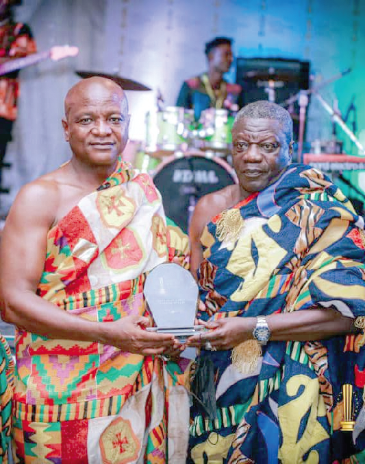 Togbe Afede (left) receiving his plaque from Daasebre Kwebu Ewusi Paramount chief of the Abeadze Traditional Area