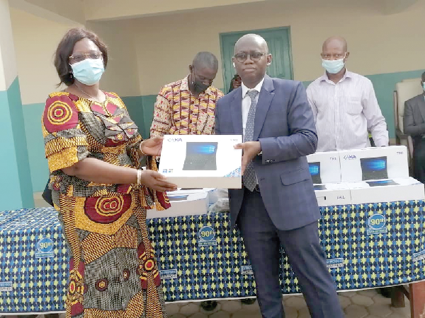 Prof. Kwasi Opoku-Amankwa (right), Director-General of GES, presenting a laptop to Madam Rejoice Akua Acorlor, Headmistress of O'Reilly SHS.