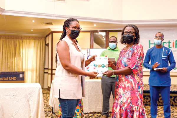 Ms Pamela Okyere (2nd from right), Independent Consultant, presenting the report on Fruit Processing in Ghana to Ms Sandra Snowden, Managing Director, Hendy Farms
