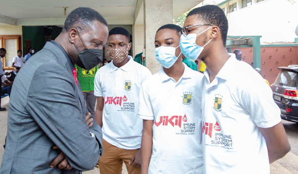 Dr Yaw Osei Adutwum interacting with the National Science and Maths Quiz winners from Prempeh College in Kumasi during the visit
