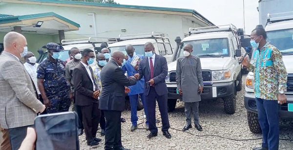 Mr Kwaku Agyeman-Manu, Minister of Health, symbolically handing over the keys to the vehicles to Dr Patrick Kuma-Aboagye (3rd from right), Director-General of the GHS