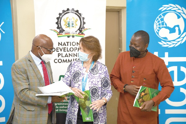 Nana Dr Ato Arthur (left), Head of the Local Government Service, discussing the report with Ms Anne-Claire Dufay, UNICEF Representative to Ghana, after the launch. With them is Mr Richard Fedieley,  Ministry of Local Government. Picture: EBOW HANSON