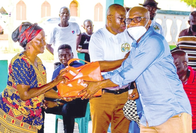 Dr Arthur (right) presenting a package to one of the beneficiaries