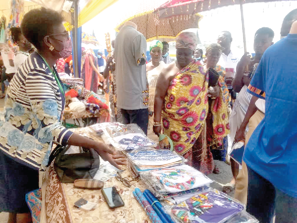 Nana Amoanimaa Dede II, the Adansihemaa and other patrons taking a look at some of the goods on display