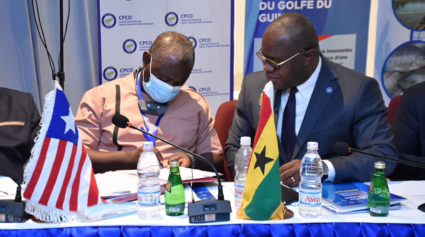 The Chief Director of the Ministry of Fisheries and Aquaculture Development, Mr Eric Kwesi Armo-Himbson (left) signing the pact. Looking on is the Secretary General of FCWC, Mr Seraphin Dedi Nadje.