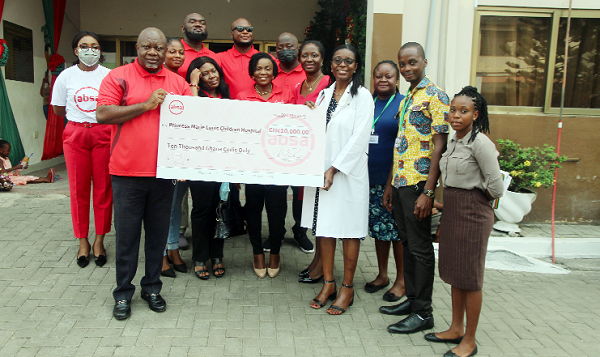  Mr Owusu Agyeman (left), the Head of Premier Banking, Absa Bank, presenting a dummy cheque to Dr Mame Yaa Nyarko (4th from right), a Medical Doctor at the hospital. Picture: ESTHER ADJEI