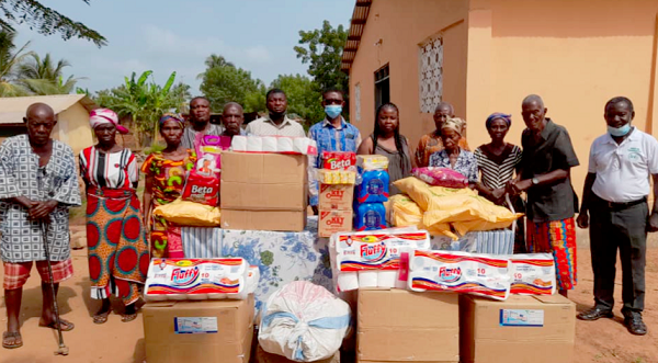  Mr Blessed Ayisi (standing middle) with some of the elderly after the donation. With him are officials of the church and the NGO.
