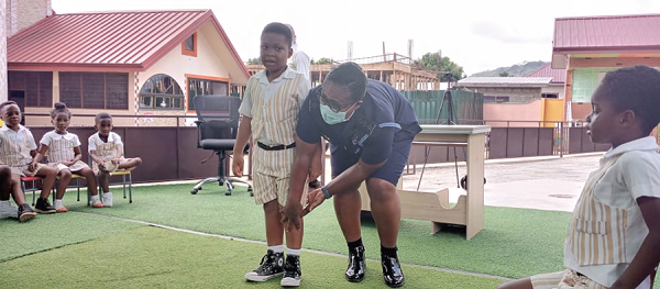  DSP Effia Tenge in a demonstration with one of the pupils during the sensitisation session
