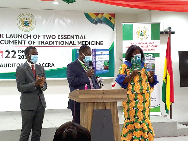 Mr Kwabena Oku-Afari (middle), Chief Director, Ministry of Health, being supported by Dr Anastasia Yirenkyi, Director in charge of the Tradional and Alternative Medicines Directorate of the MoH, to launch the two policy documents 