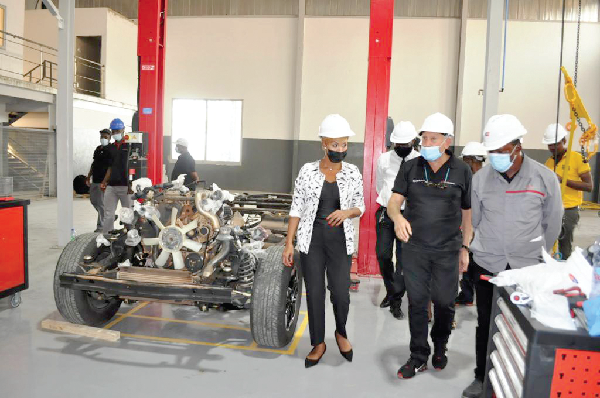 Ms Grace Jeanet Mason (left), South African High Commissioner to Ghana, being taken on a tour by officials of Japan Motors