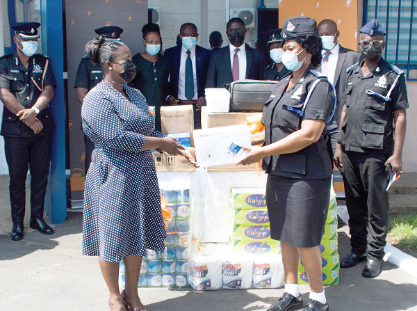  Ms Sophia Kafui Teye (left), Business Development Manager, Fidelity Securities Ltd, handing over medical supplies to CSP Juliana Agyeiwaa Dartey, Director, Nursing Services, Police Hospital