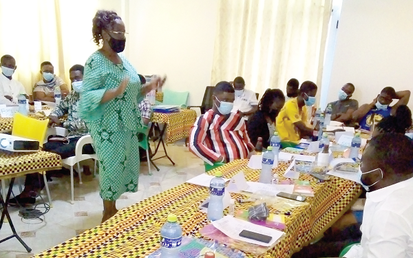  Ms Rebecca Onyame (standing), the lead facilitator, taking the participants through the training