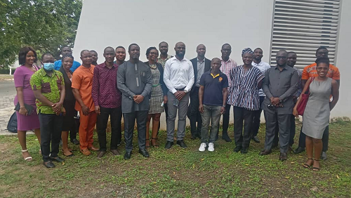 Dr Philip Kofi Adom (in white shirt) in a group photo with the participants at the workshop 