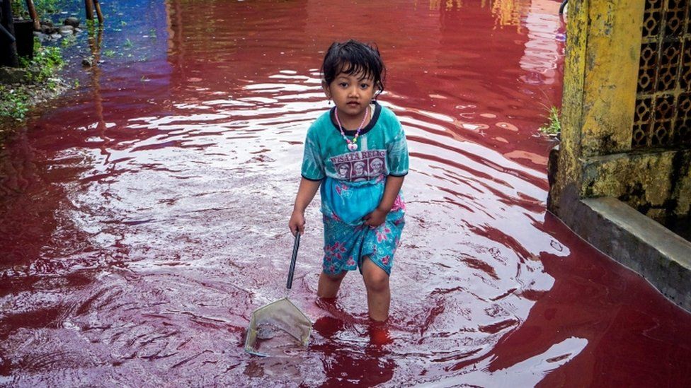Indonesian village turns red as floods hit batik-manufacturing hub