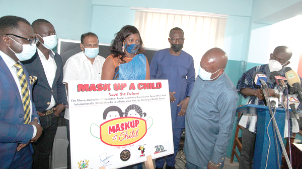 Mr Kwaku Agyeman-Manu (right), Minister designate for Health looking at poster. With him are Mr Affail Monney (2nd right), President of the Ghana Journalists Association; Mr Sugandh Raharam (left), Indian High Commissioner to Ghana and Ms Gladys Biney (2nd left), President of the Auntie is Merkeze Organisation. Picture : ESTHER ADJEI