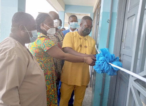 Mr Isaac Appaw-Gyasi (right) and Dr Ghann cutting the tape to commission the cyber security centre as some staff look on