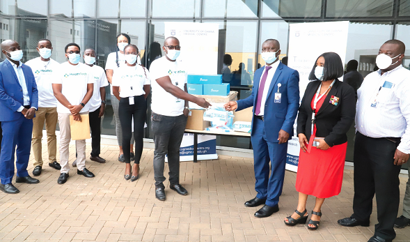 Mr Daniel Morkla (6th left), Chief Executive Officer of HealthTech Ghana Limited, presenting the medical equipment to Dr Kwame Anima-Boamah (3rd right), Director of Medical Affairs of the University of Ghana Medical Centre at the ceremony in Accra. Those with them include staff of HealthTech Ghana Limited and the University of Ghana Medical Centre. Picture: GABRIEL AHIABOR