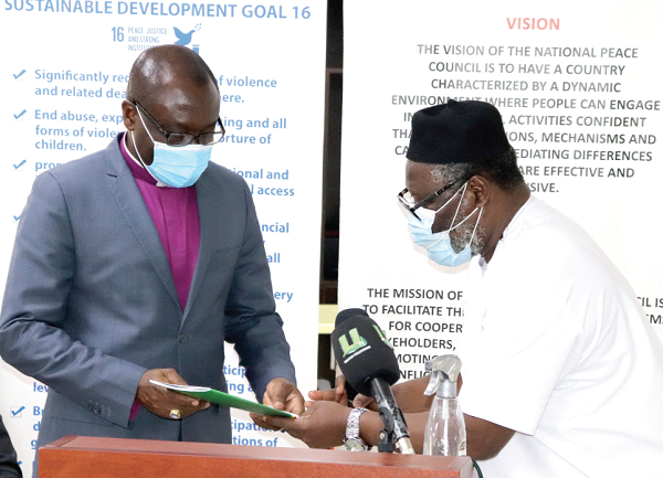 Rev Dr Nii Amoo Darko (right) presenting the handover notes to Rev. Dr Ernest Adu-Gyamfi