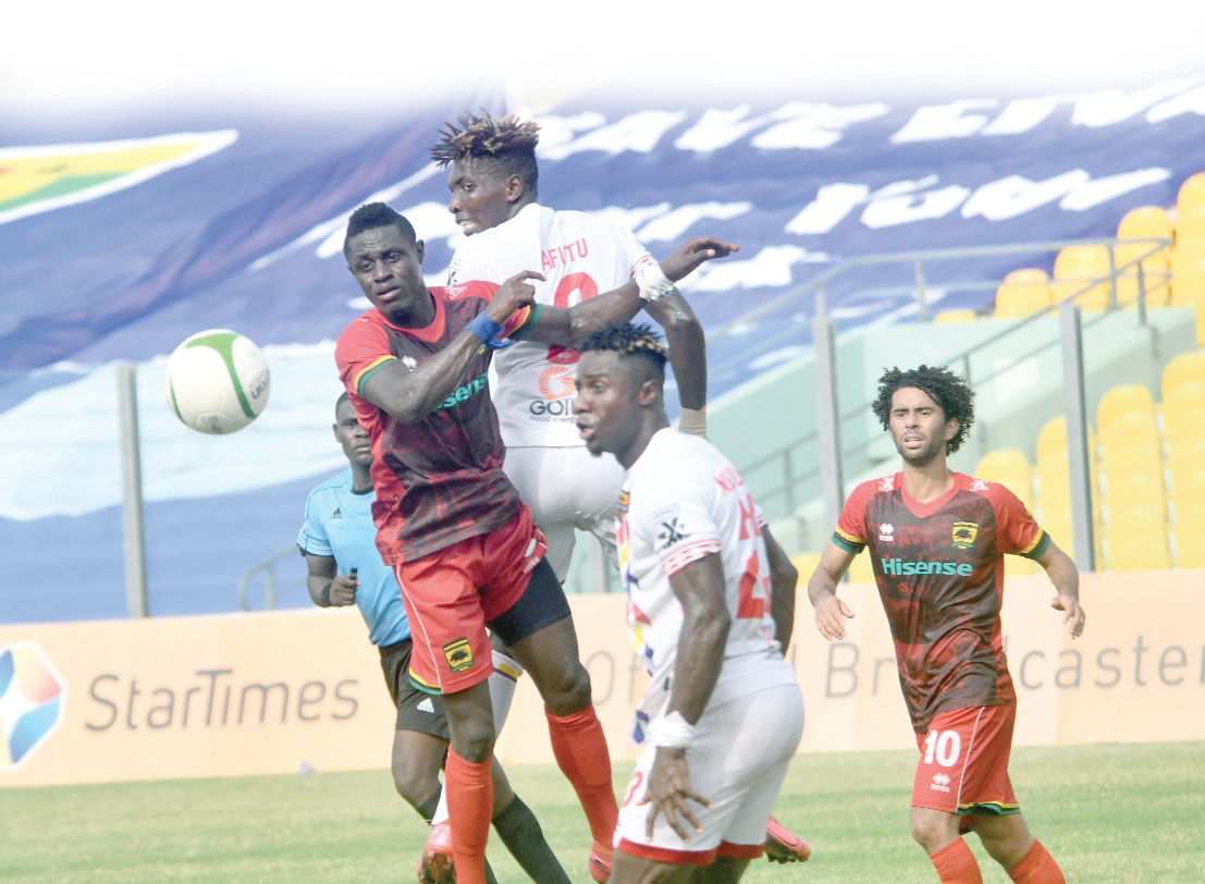 Kotoko’s  Kwame Opoku (left) and Benjamin Afutu (second left) cleared the ball with a header. Picture: EBOW HANSON