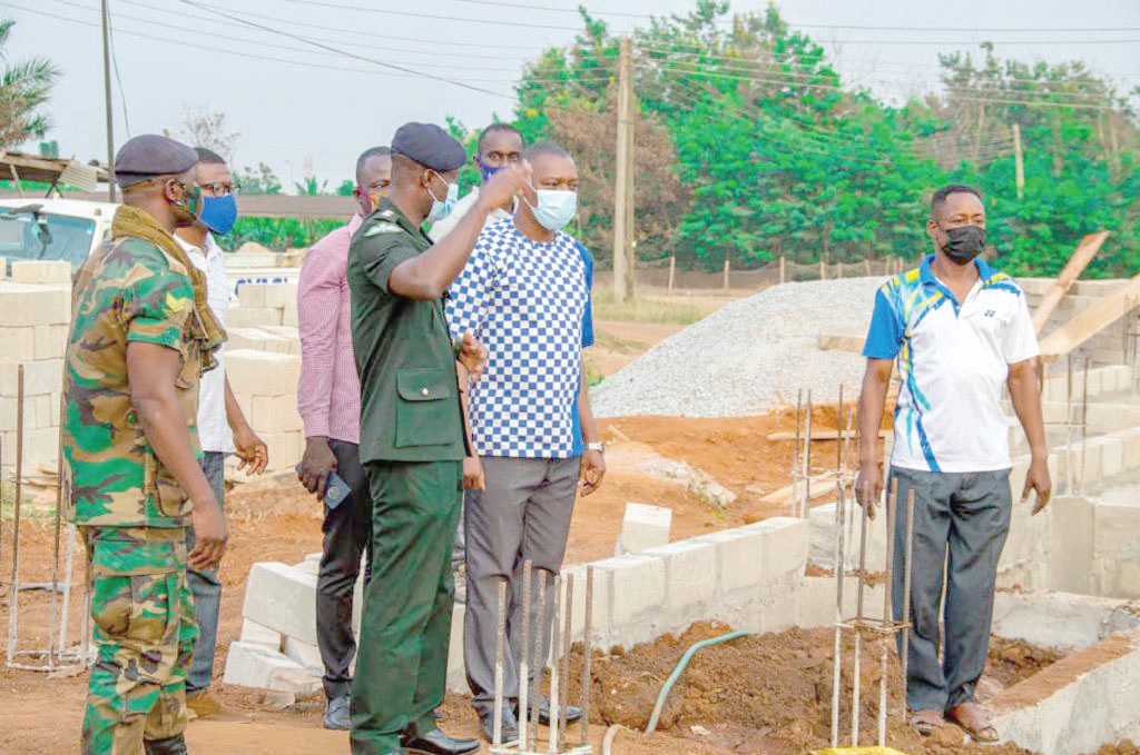 Lt Col Dominic Ampomah (hand raised), Deputy Command Operations Officer, taking Dr Kingsley Nyarko, the MP, round the project site