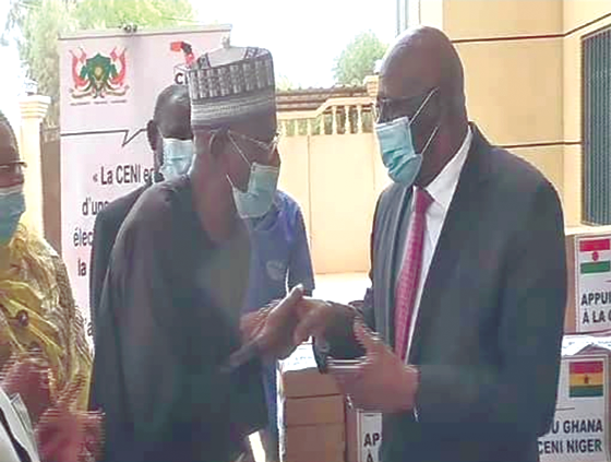 Mr Jonathan R. Magnusen (left) presenting the items to Mr Issaka Souna