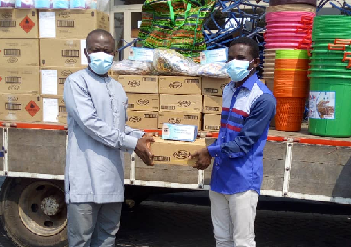 Mr. John Alate, Accra Project Officer, Water and Sanitation for the Urban Poor (right) presenting the items to  Mr. Mohammed Adjei Sowah, Chief Executive, Accra Metropolitan Assembly (left)