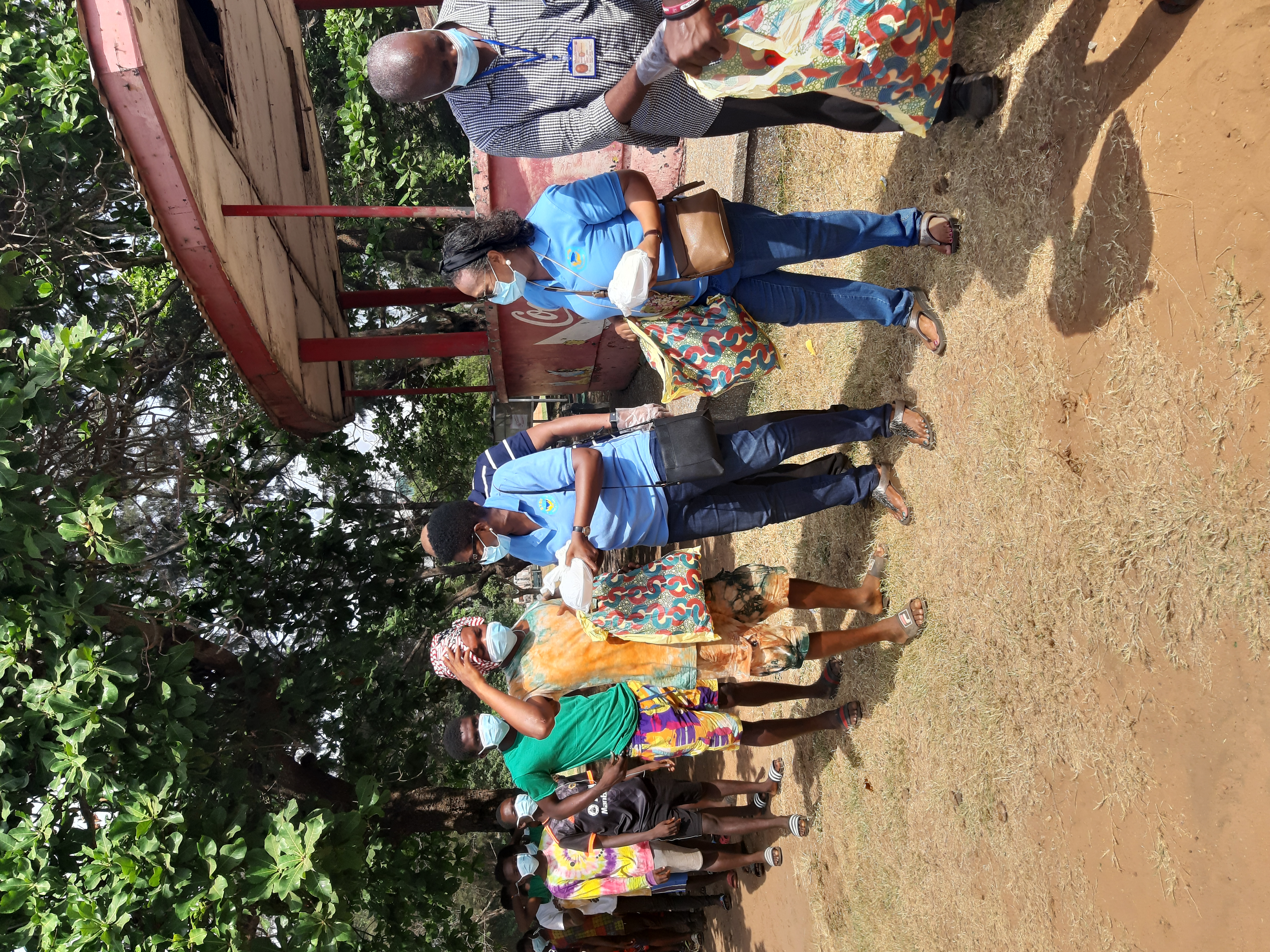 Mrs Adjoa Amana (3rd right) Director of EYEH Soup Kitchen handing over a gift package to one of the drug addicts, while the other beneficiaries wait for their turn. With her is Mrs Elizabeth Quashie-Idun, (2nd right) a Co-Director of the NGO