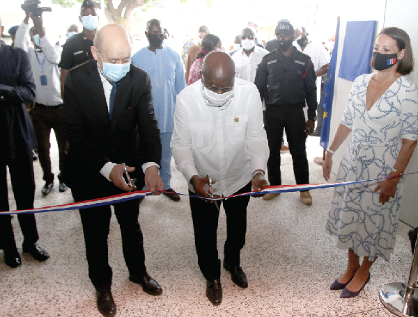  President Akufo-Addo together with Mr Jean-Yves Le Drian (left) cutting the tape for the inauguration of the building. Picture: SAMUEL TEI ADANO