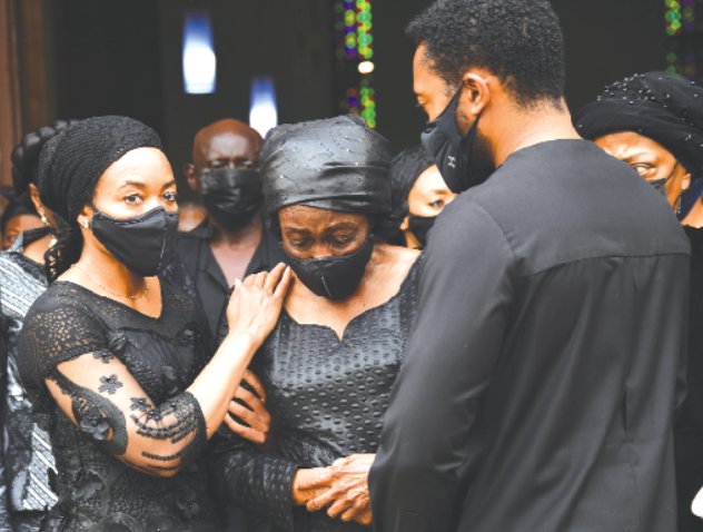 Ms Zanetor Agyeman Rawlings (left) and her brother, Kimathi Agyeman Rawlings (right), consoling their mother, Nana Konadu Agyeman Rawlings, after the Requiem Mass. Picture: EBOW HANSON 