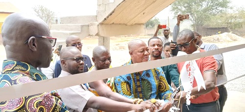 Nana Akowuah III (arrowed) being assisted by Francis Assenso -Boakye (2nd from left), MP for Bantama, and Sam Pyne (4th from left), MCE of KMA, to inaugurate the classroom block