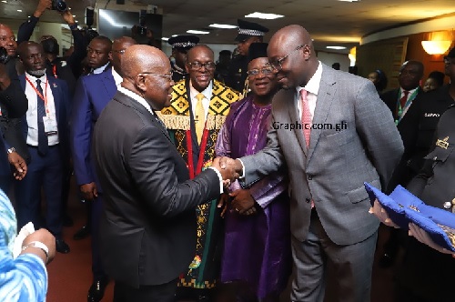 President Akufo-Addo (left) exchanging pleasantries with Dr Ato Forson (FILE PHOTO)