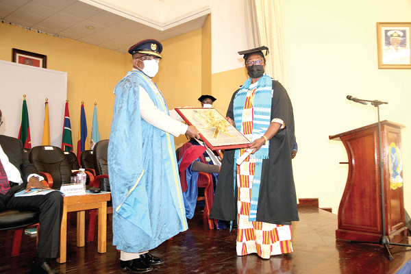  Major General Francis Ofori (left), Commandant of KAIPTC, presenting the best student award in Master of Arts in Gender to Ms Magdalene Mary Awinyeliya Kannae (right). Picture: ESTHER ADJEI