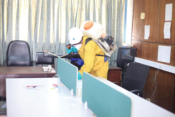  A member of the Zoomlion team spraying and disinfecting one of the offices at the headquarters