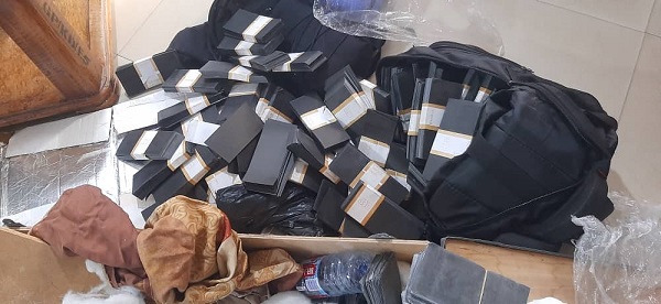 Some papers cut into the shapes of currency notes suspected to be used by the suspects