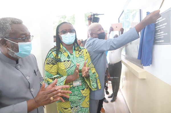  Alhaji Asei Mahama Seini (right), a Deputy Minister of Health, unveiling a plaque, while Prof. Akosua Dickson (middle) and Dr Nsiah-Asare applaud during the inauguration. Front view of the KNUST-IVI Collaborating Centre in Agogo. 