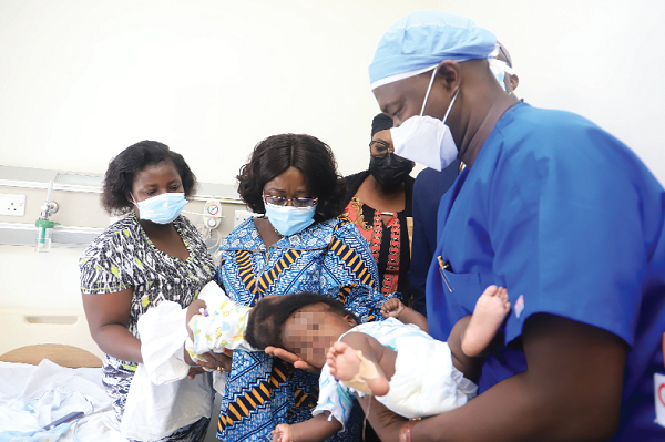 Mrs Akosua Frema Osei-Opare (2nd left), the Chief of Staff, with Dr Samuel Kaba Akoriyea (right), Lead Consultant and Neurosurgeon of the team, and Madam Justine Bansah, mother of the conjoined twins
