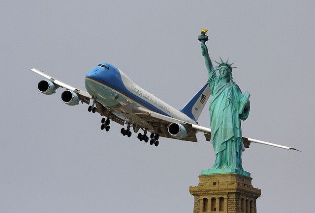  The statue of Liberty with a Delta Airline aeroplane flying above it