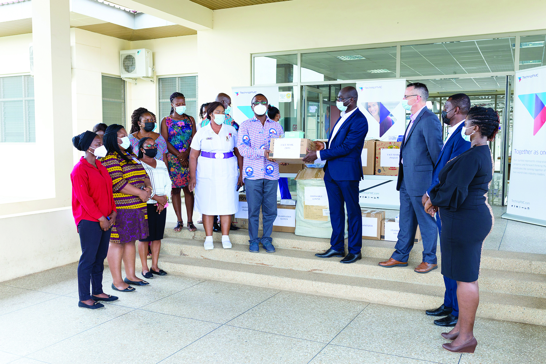 Dr Joseph Dankwah (4th right) presenting the PPE to an official of the Ga East Municipal Hospital