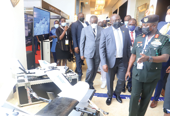 Brig.Gen. Matthew Essien (right), Brigade Commander, leading Vice-President Dr Bawumia to inspect locally manufactured drones at the exhibition. With them is Mr Dominic Nitiwul