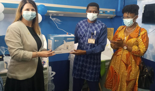   Ms Barbara Nel (left), Country President, Africa Cluster for AstraZeneca, handing over the stations to Dr Hamidu Abdulai  (middle), Director of Pharmacy, TTH . With them is Dr Sylvia Vito, Head of Africa Acceleration of AstraZeneca
