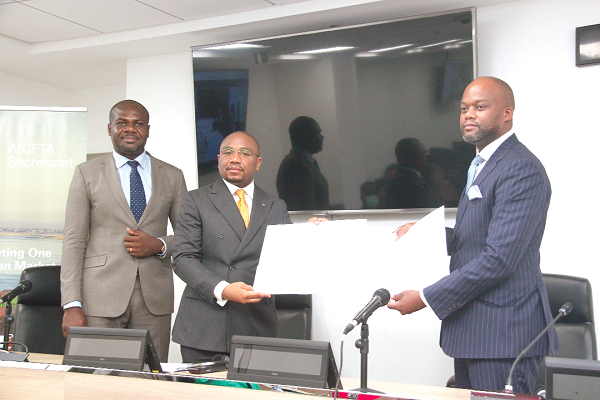 • Mr Wamkele Mene (right), Secretary General, African Continental Free Trade Area, and Mr Patient Sayiba Tambwe (middle), President, Union of African Shippers’ Councils, showing the signed MoU documents to the press. With them is Mr Giscard Lilian Ogoula (left), Secretary General of the union