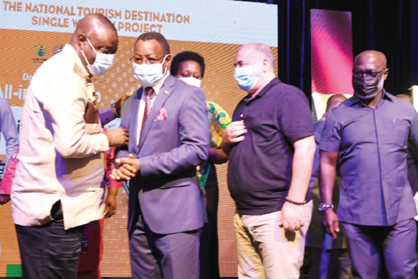 • Dr Mohammed Ibrahim Awal, Minister of Tourism, Arts and Culture, interacting with Ambassador Eliphas M. Barine, the Kenyan High Commissioner to Ghana, after the launch of the national tourism destination single window project in Accra. With them are Mr Ahmed Naamann (2nd right), Director of Dodi Travel and Tours, and some other guests.